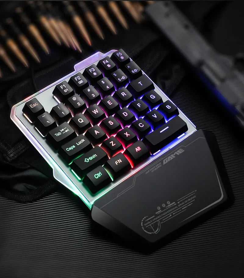 Black robotic one-handed G40 keyboard with RGB backlit keys on a desk.