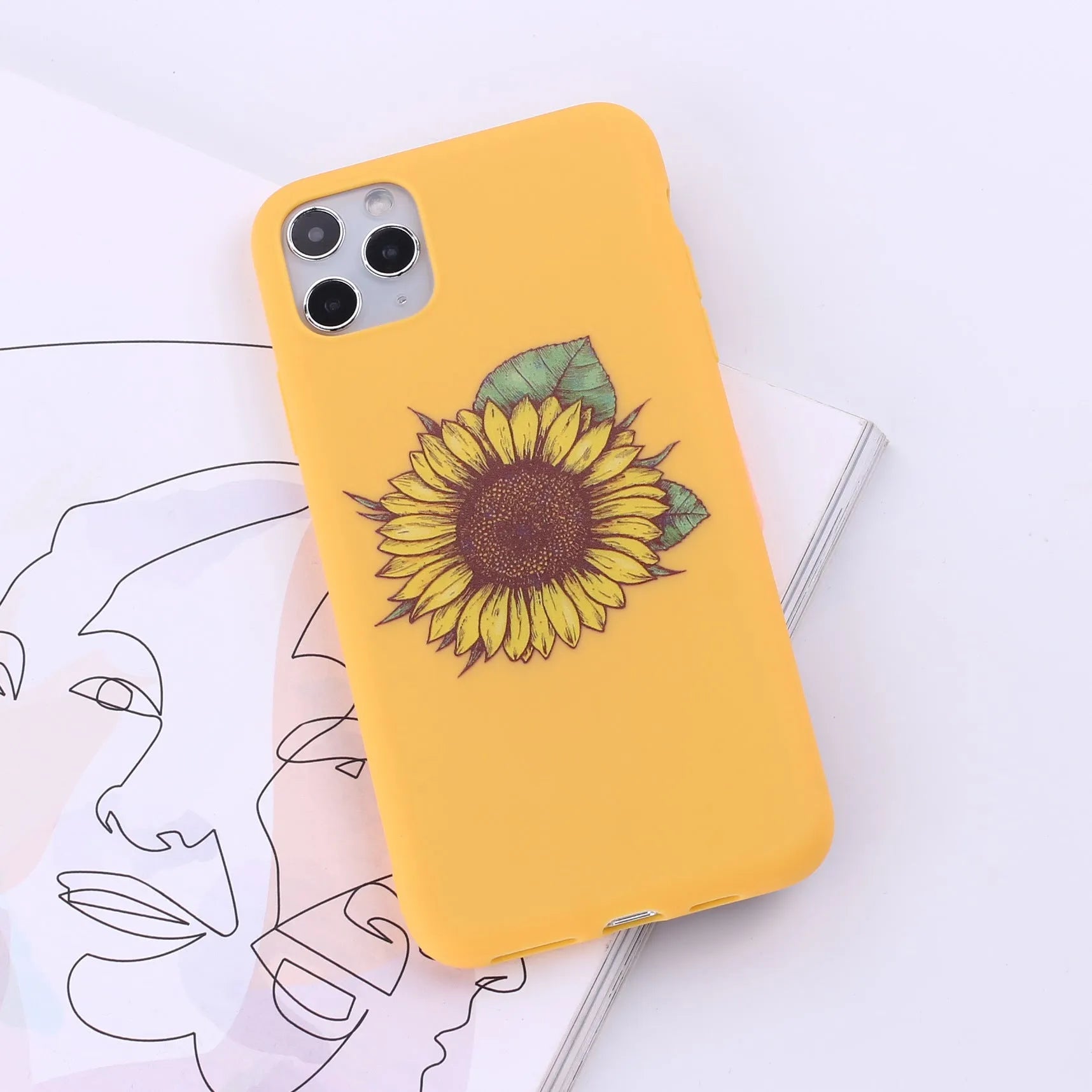 Slim TPU mobile phone case for iPhone on a table, showing one of 14 available colour options.