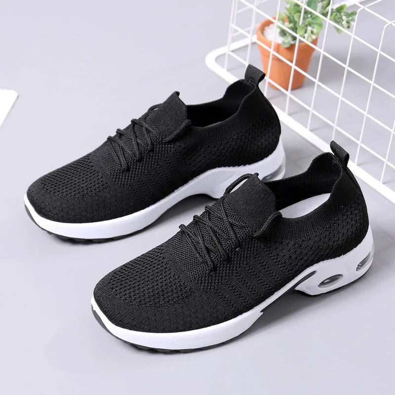 Women's black mesh sneaker with lace-up front and round toe on a non-slip PVC sole.