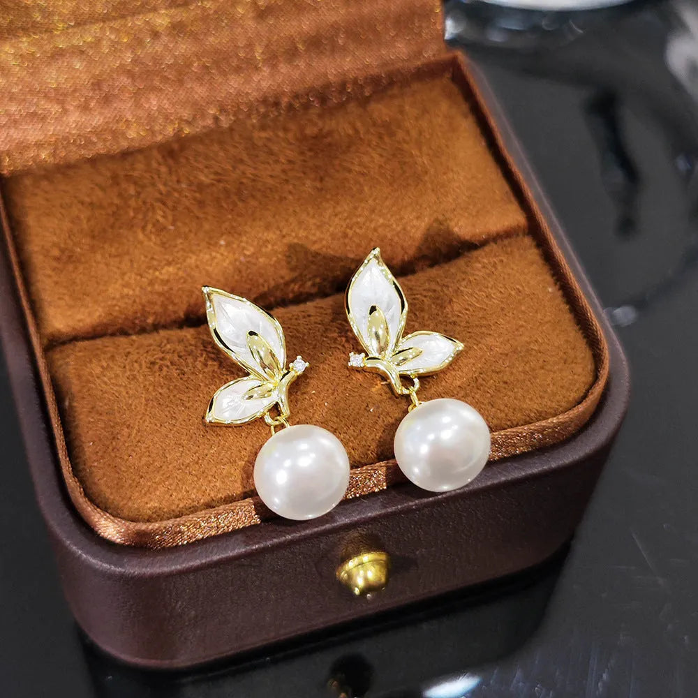 A pair of women's butterfly stud earrings in electroplated copper, colour PT0203, with simple style and painted zircon detail.