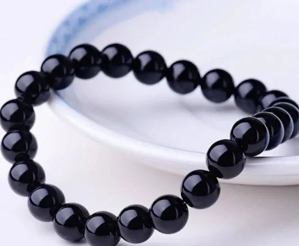 Geometric black agate bead bracelet for women with 8mm stones on a stretch elastic cord.