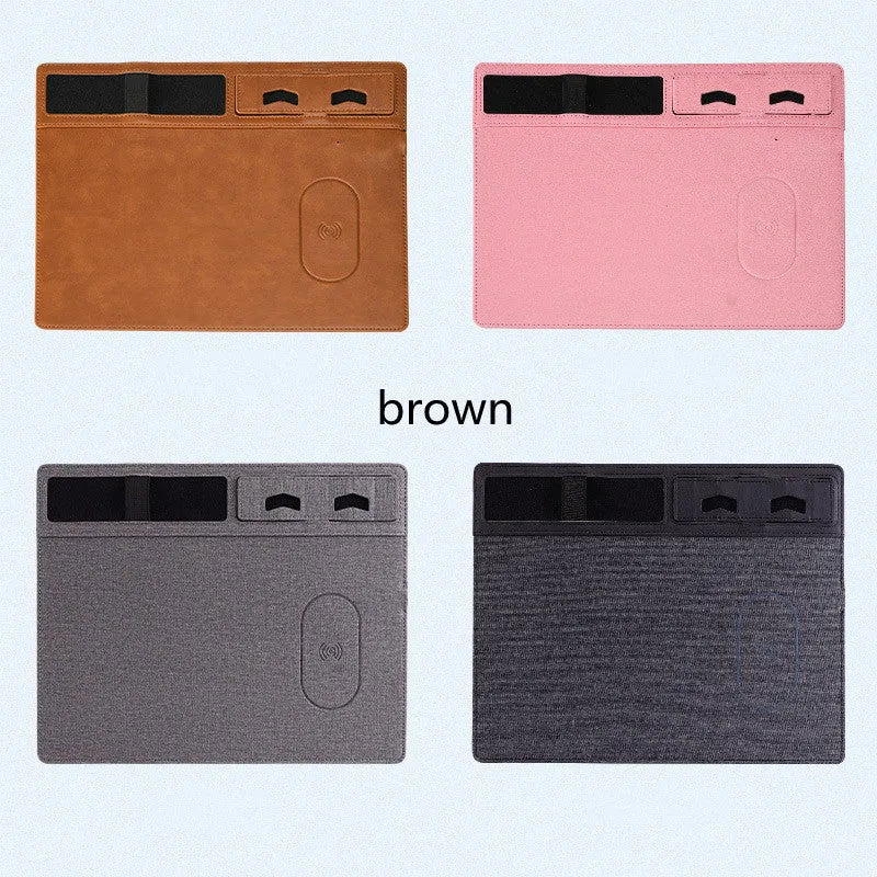 Pink PU leather wireless charging mouse pad with phone holder on a desk, showing USB cable.