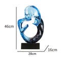 Transparent resin ornament with polished surface in blue colour on shelf