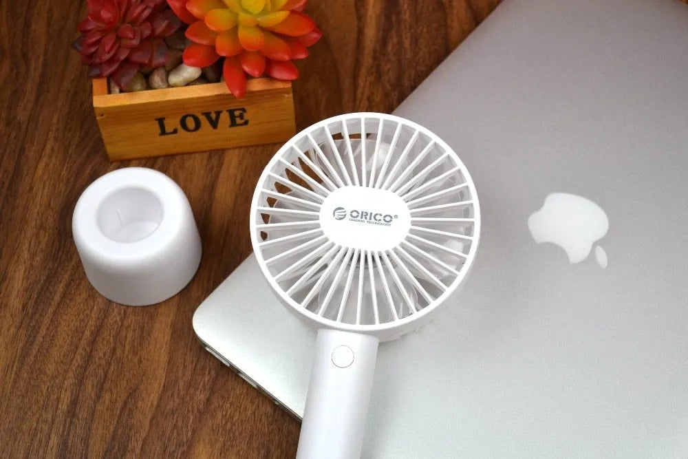 White ORICO FH1 portable USB desk fan with fine line design on a desktop.