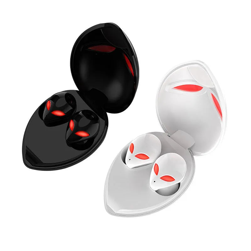 Creative Outer T8 Starman alien design wireless earbuds with LED lights next to charging case.