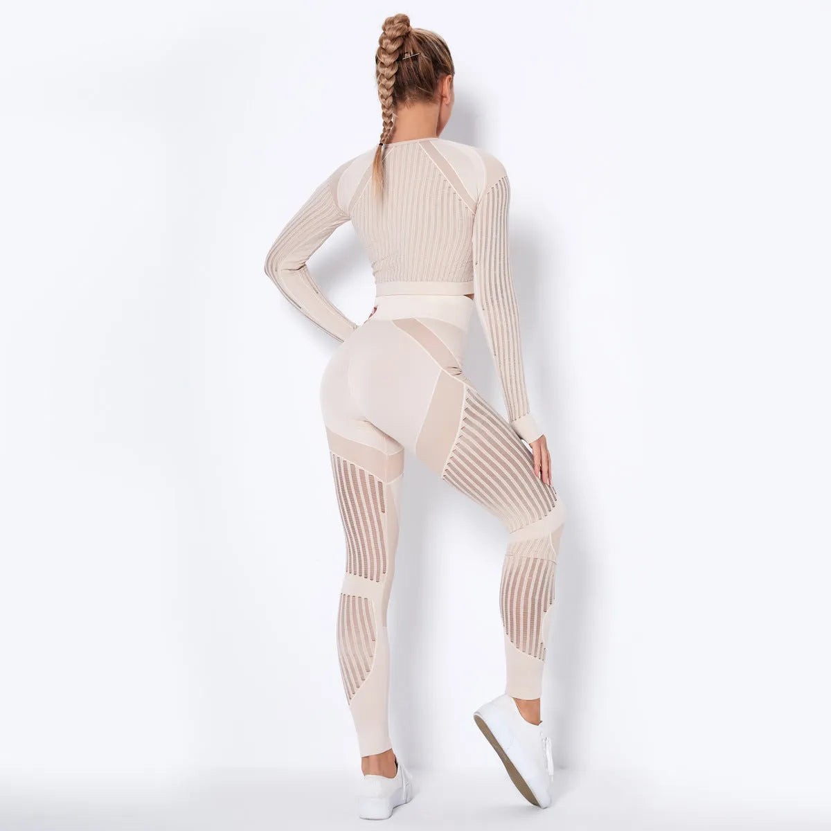 Women's long-sleeved seamless knitted yoga suit in a neutral colour, showing the stretch fabric and close fit.