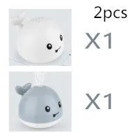 Automatic water spray whale bath toy floating in water with fountain and LED lights