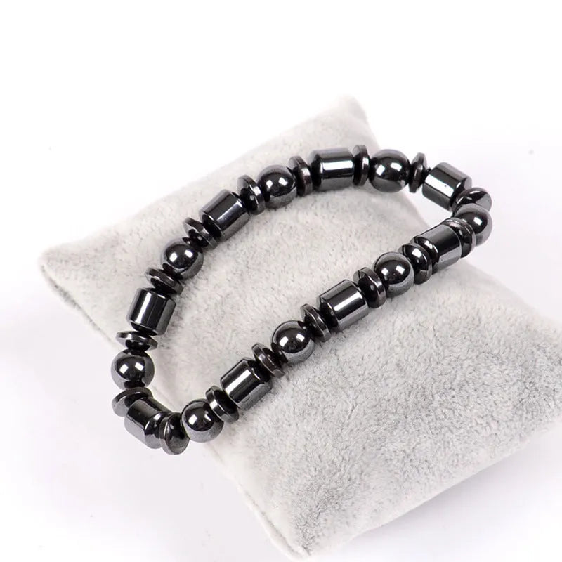 Black pentagram stone magnetic therapy bracelet with magnetite and hematite beads on a stretch band.