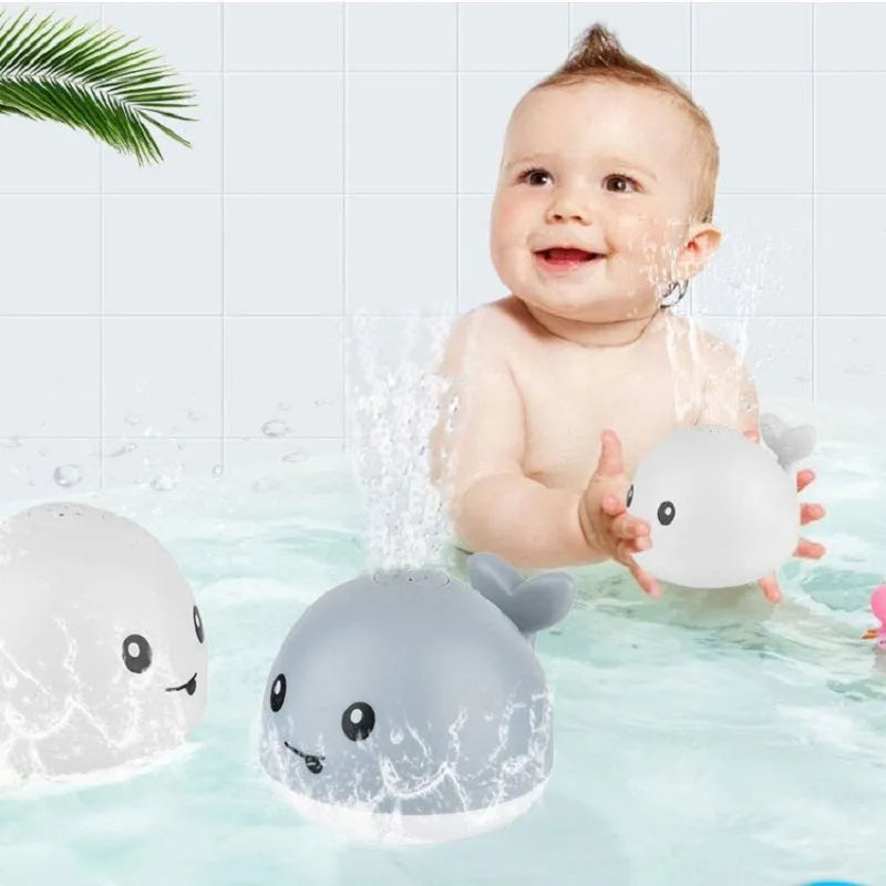 Automatic water spray whale bath toy floating in water with fountain and LED lights
