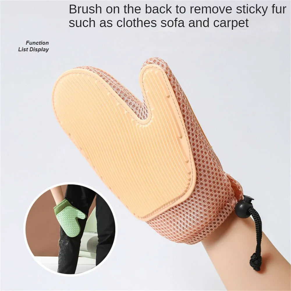 Right hand pet grooming glove in blue on fabric, showing mesh texture for removing cat and dog hair.