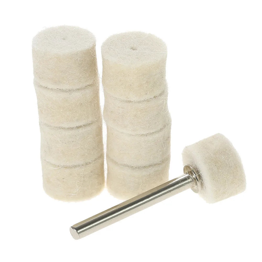 Polishing wheel accessories 129-piece set with white wool brushes and metal grinding wheels on a workbench