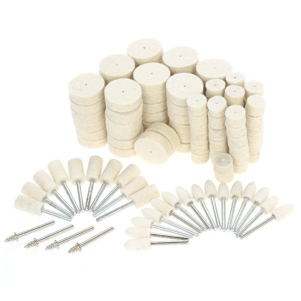 Polishing wheel accessories 129-piece set with white wool brushes and metal grinding wheels on a workbench