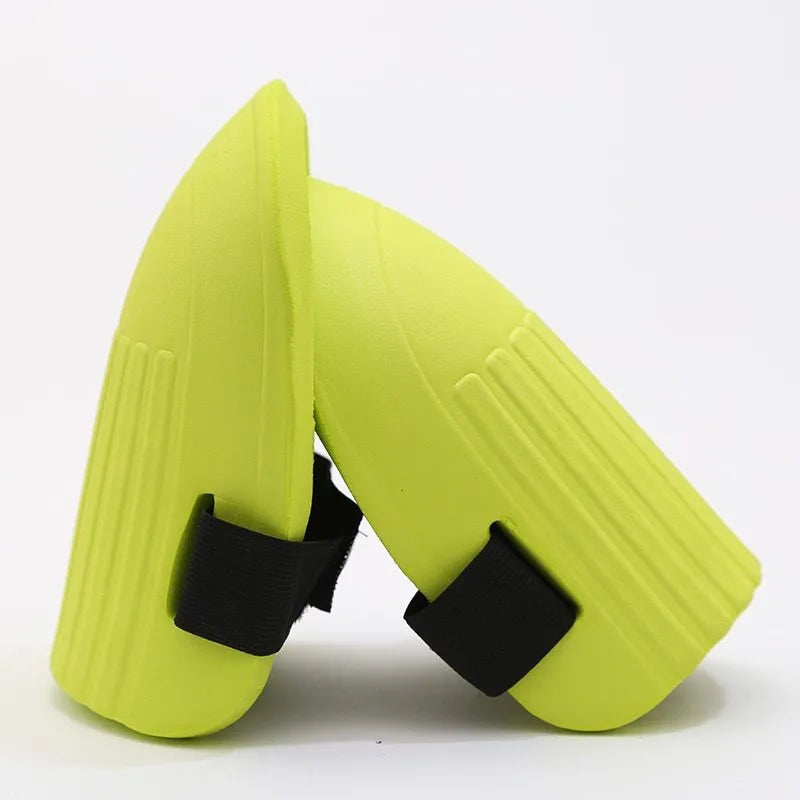 A pair of thick EVA foam knee pads in army green colour on grass.