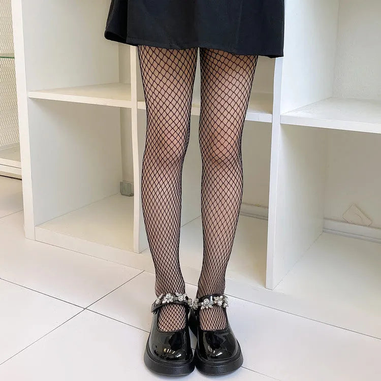 Women's mesh stockings showing large, medium and small patterns in black and white colours