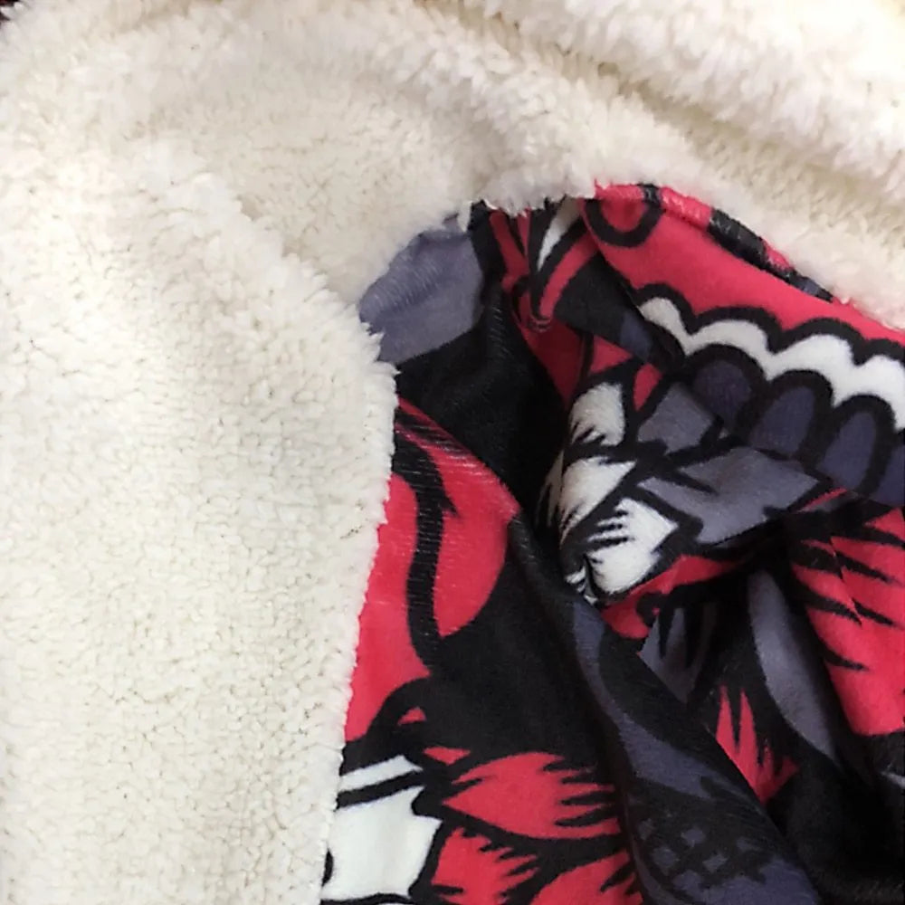 Round coral fleece flannel blanket rolled in a burrito style, showing soft texture and printed design.