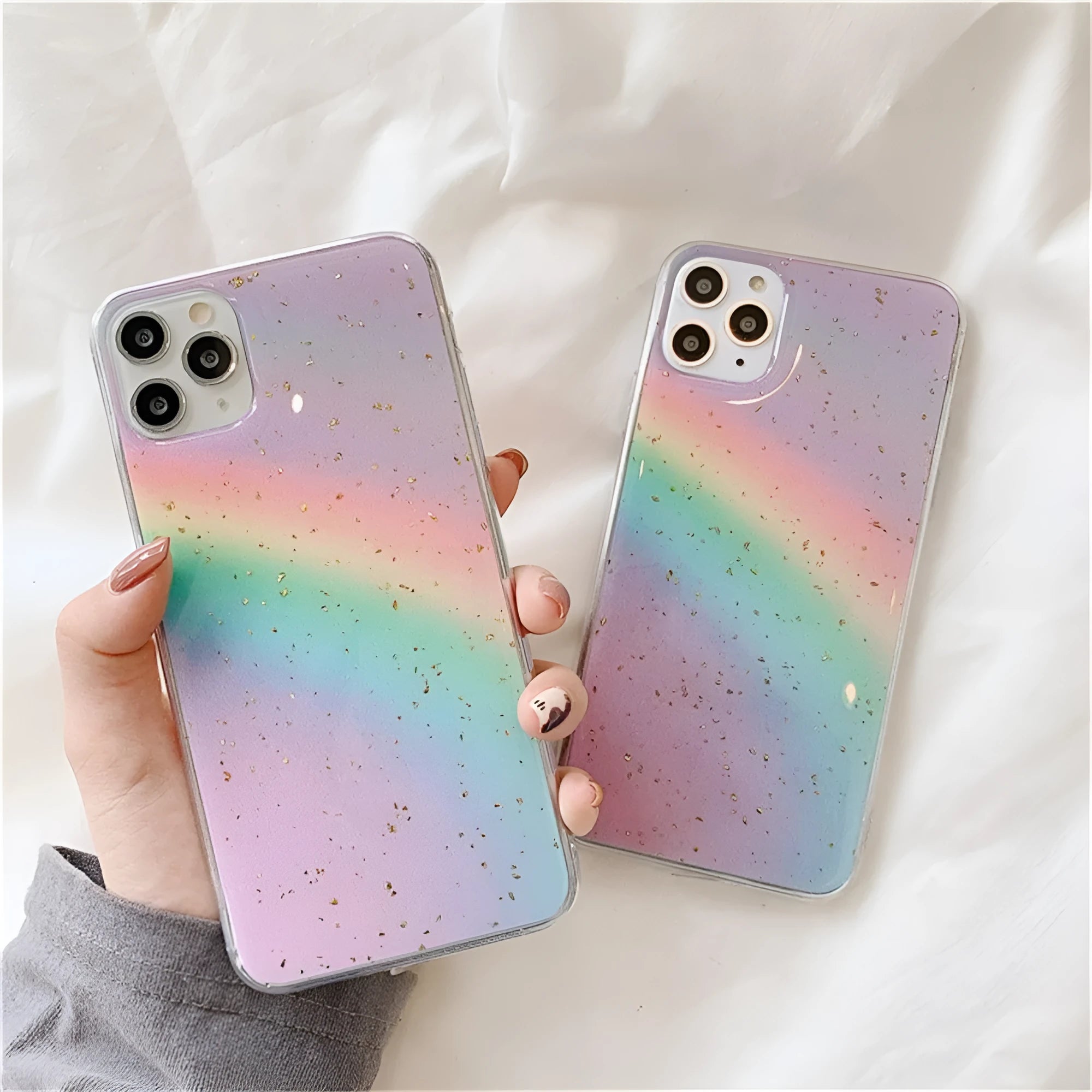 Rainbow gradient iPhone case with striped design on a phone