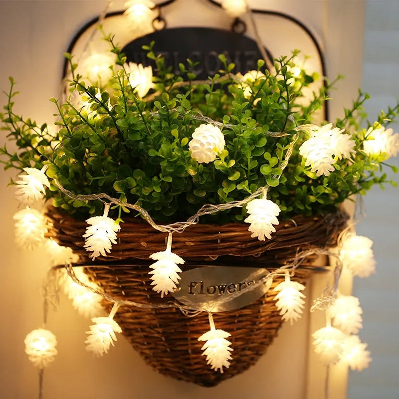 Warm white LED pine cone battery-powered string light draped decoratively