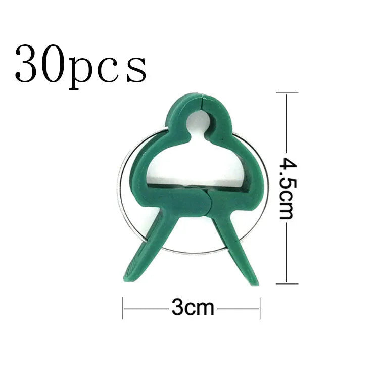 Green plastic plant fixing clips for supporting climbing vegetables like tomatoes and cucumbers