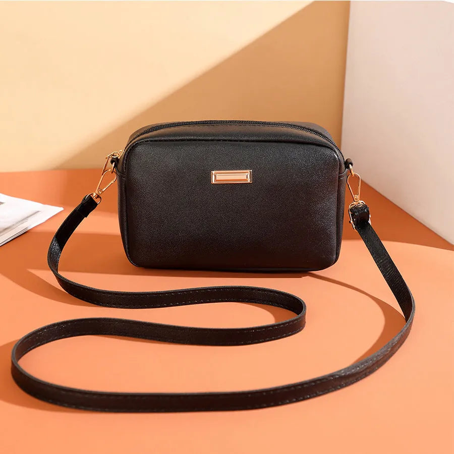 Women's solid colour PU leather shoulder bag with three-dimensional pocket and square shape.