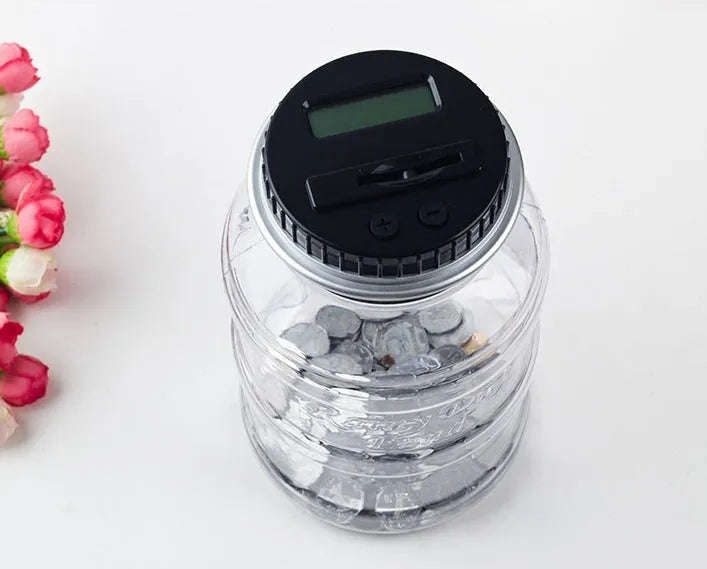 Transparent digital coin counting money box with LCD screen on black lid, 11.5cm by 20cm