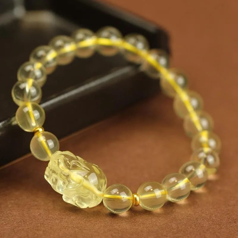 Yellow leather bracelet with an artificial citrine crystal Pi Xiu charm in Chinese national style.