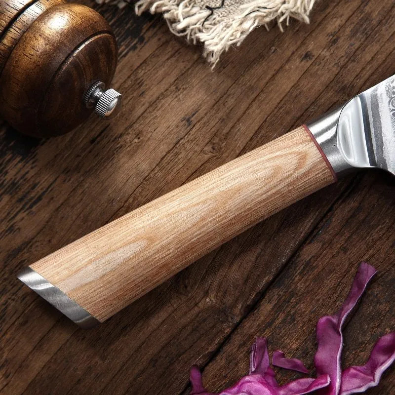 Damascus kitchen knife set with multiple blade sizes and V gold steel core on a kitchen counter.