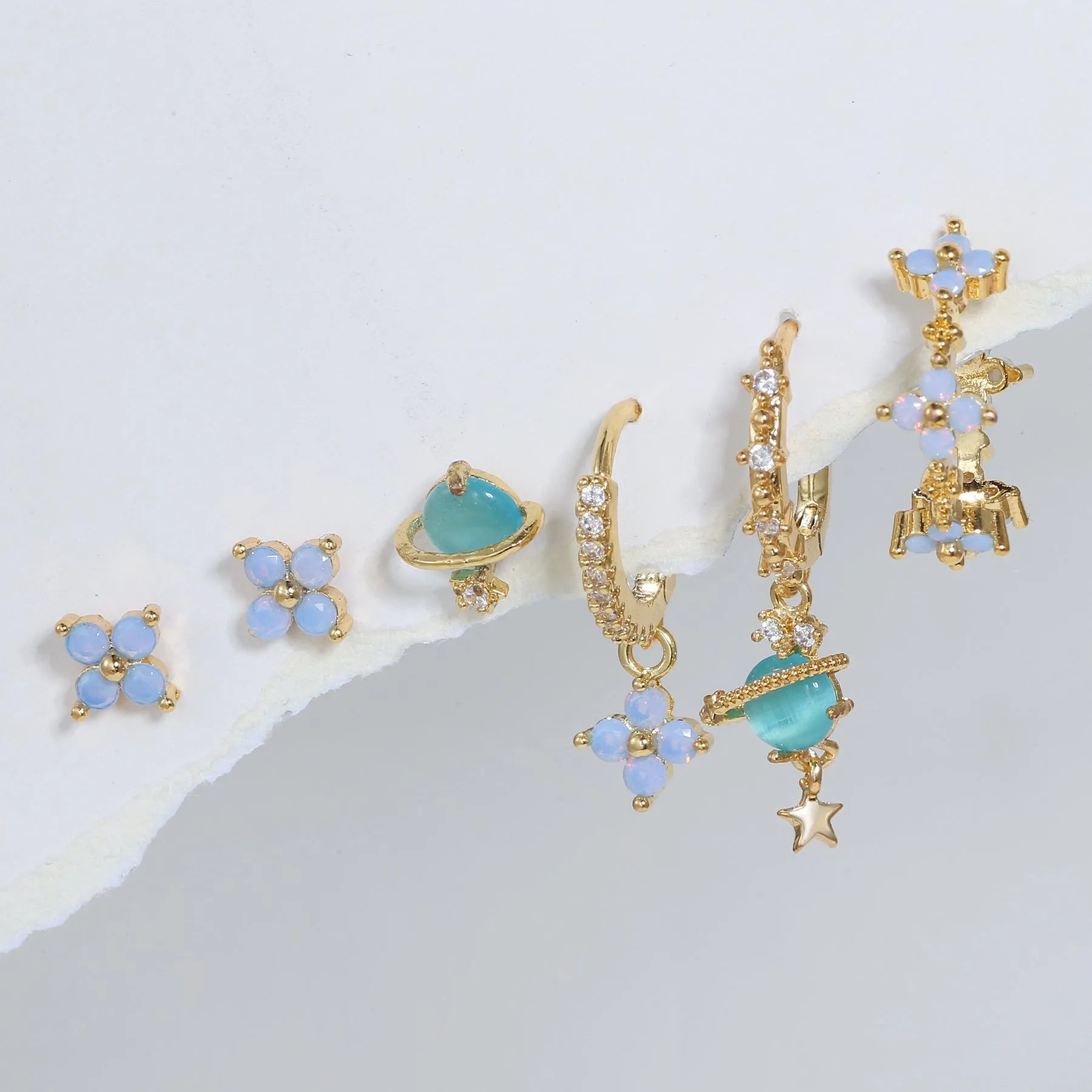 Flower shaped ear studs with blue zircon mosaic in gold and silver colour options