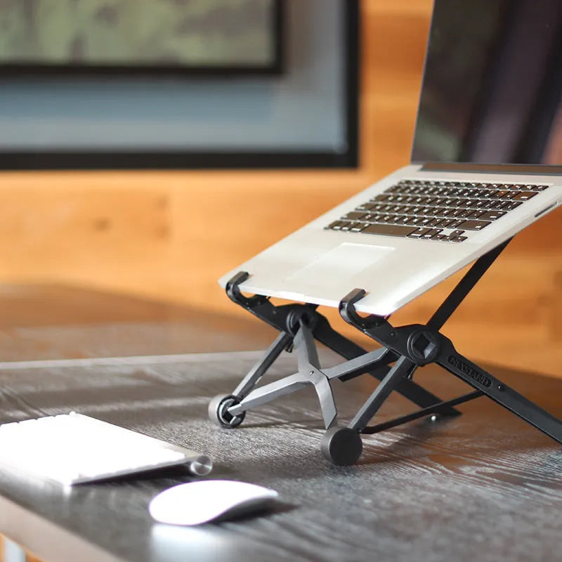 Black reinforced nylon portable folding laptop stand with 35.4cm width, shown in folded position.