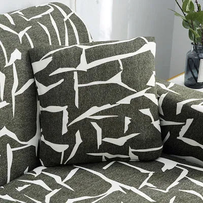 Geometric patterned stretch sofa slipcover fitted on a modern two-seater sofa.
