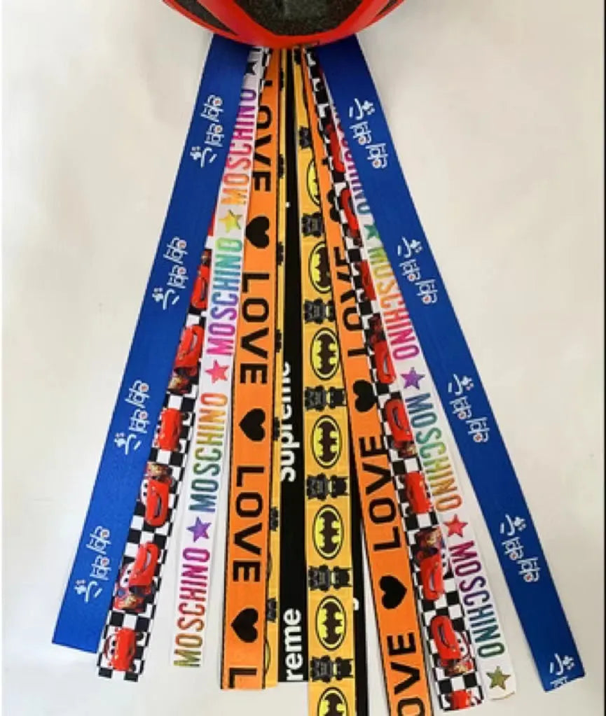 Colourful decorative ribbon streamers attached to a children safety helmet for skating or skiing
