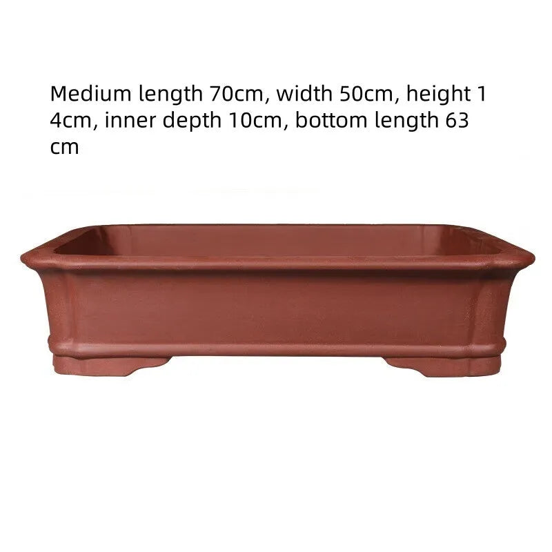 Large rectangular purple clay flowerpot for bonsai or plants, showing its handmade texture and substantial size.