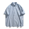 Blue striped short-sleeved shirt overalls with loose fit design on mannequin