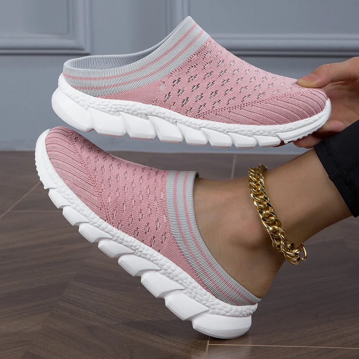 Women's black Flyknit casual shoes with striped pattern, hollowed-out design, and sewing lines on a lightweight sole.