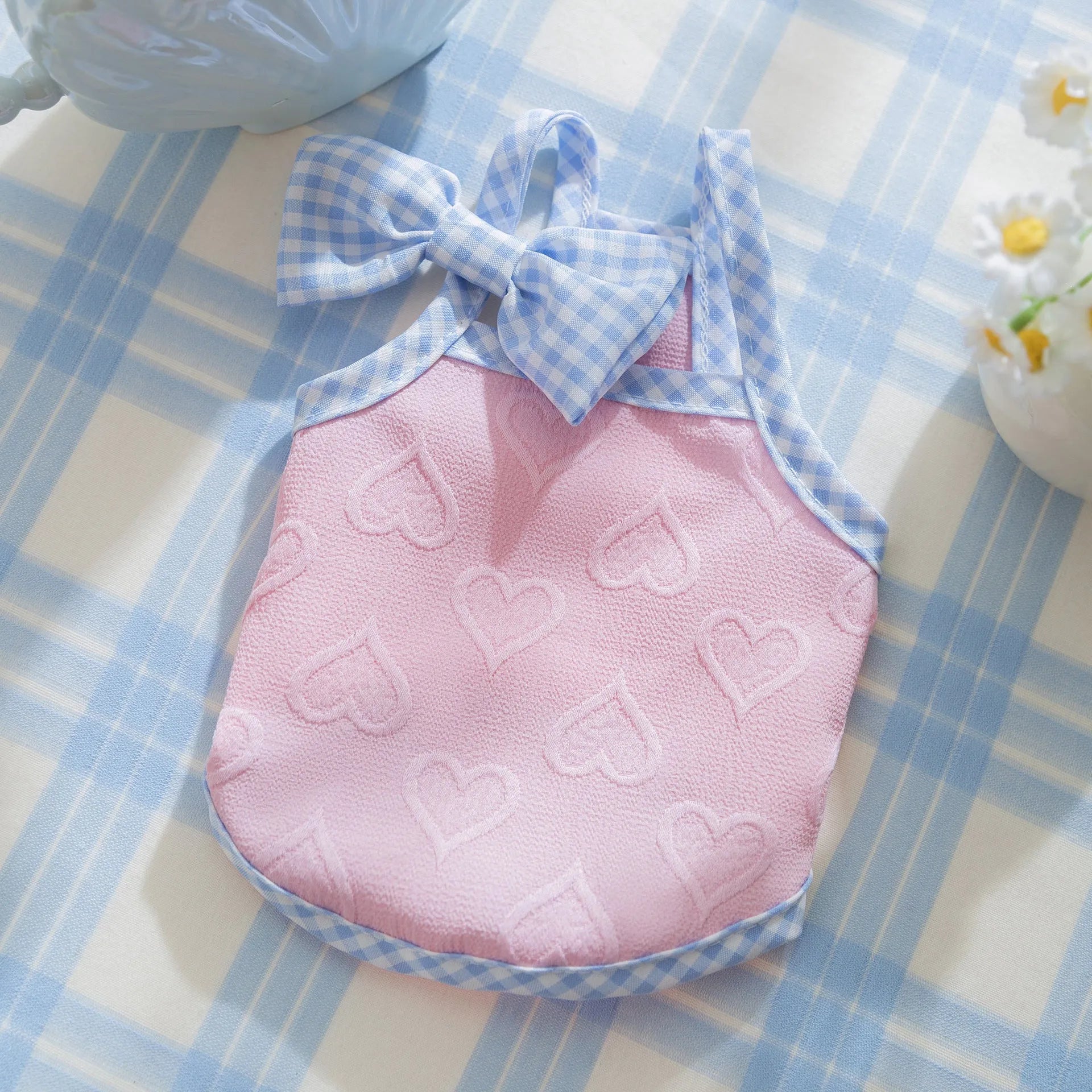 Small dog wearing heart texture vest with bow suspenders in Bondi Blue colour
