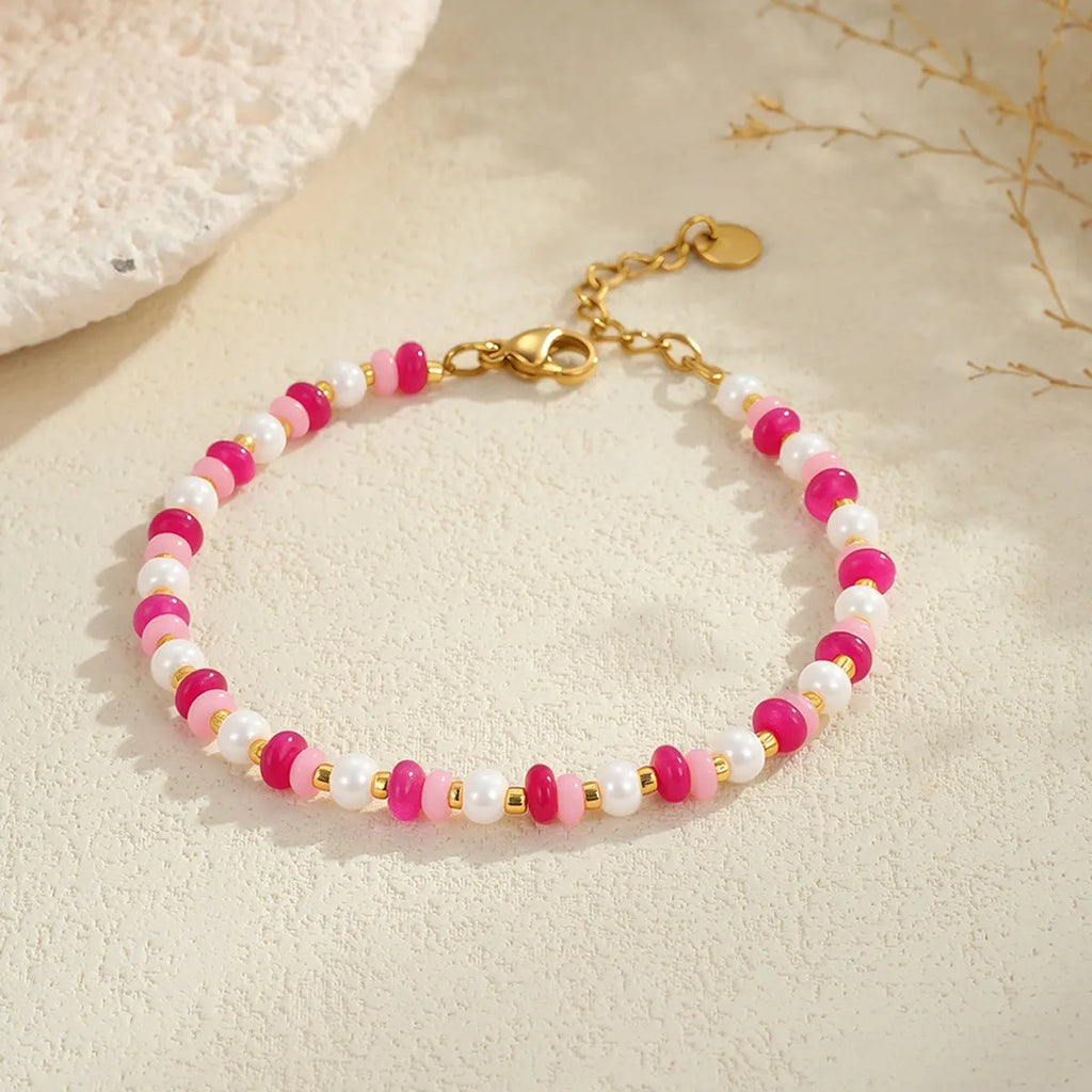 18K gold plated stainless steel chain necklace with pink electroplated resin bead pendant on white background
