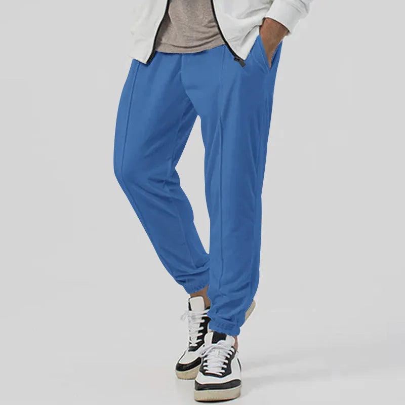 Men's grey loose tapered track sweatpants with elastic waist and straight leg design.