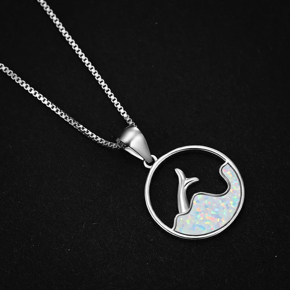 Geometric round fishtail pendant necklace with a blue opal stone on a chain, showing white gold electroplated finish.