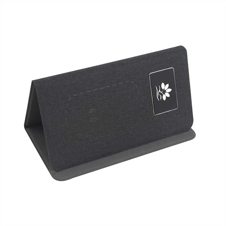 Folding wireless charging mouse pad set with Bluetooth mouse on desk, showing compact folded size