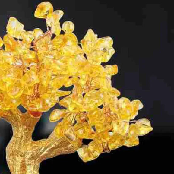 Citrine-coloured resin turtle money tree Feng Shui ornament on display.