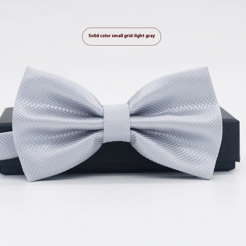 Men's flat head style polyester bow tie in a solid colour, shown with adjustable neck strap.
