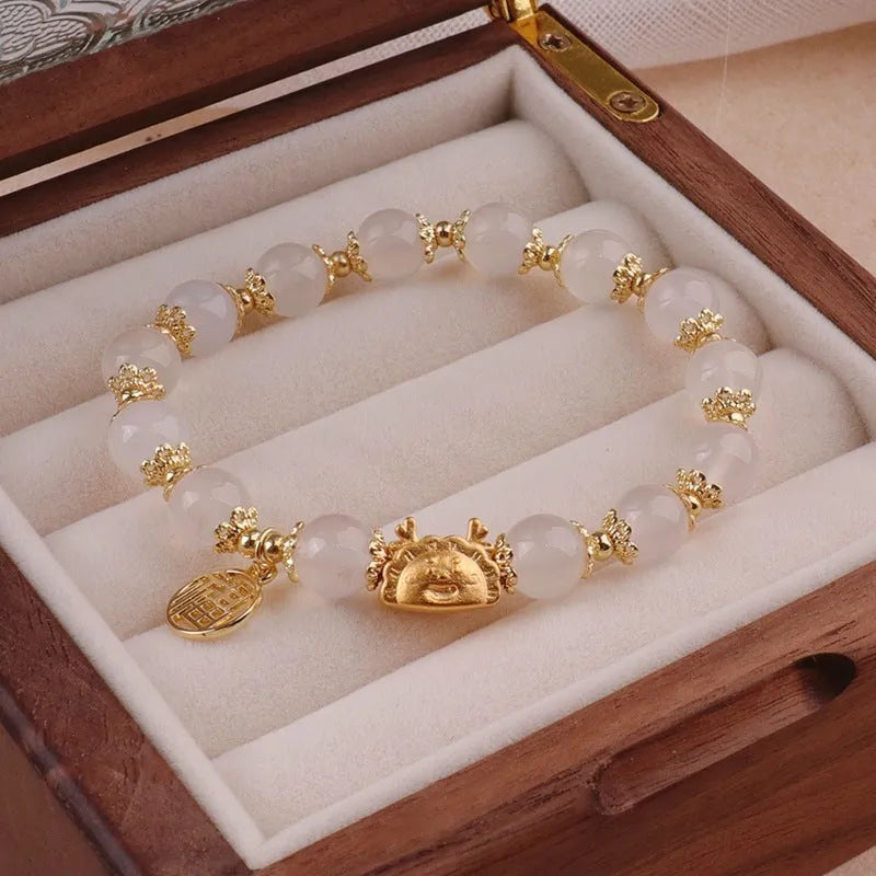 Women's floral glazed glass bracelet with animal zodiac charms in red, pink and white bead colour variations