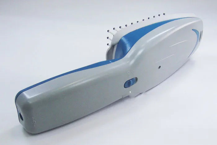Pet comb with negative ion technology, removable brush head, and 9V battery compartment.