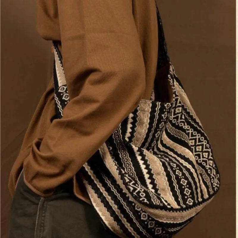 Retro striped corduroy messenger bag with vintage handprint detailing and adjustable plaid shoulder strap