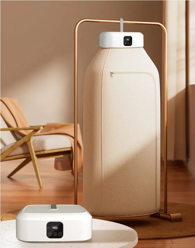 White cylindrical compact clothes dryer with remote control folded for storage