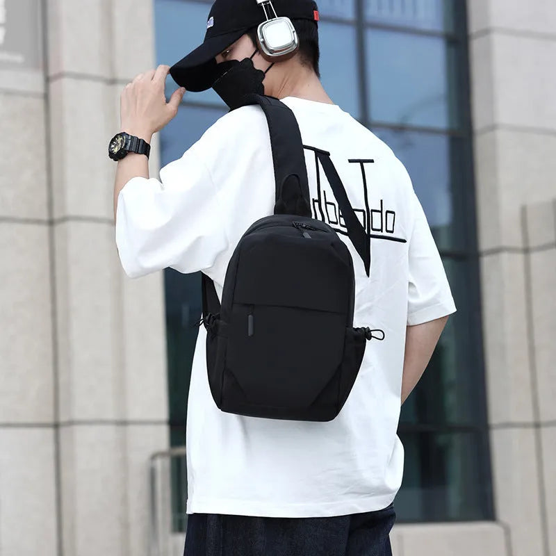 Men's grey waterproof chest bag showing front view with shoulder strap and large main compartment.