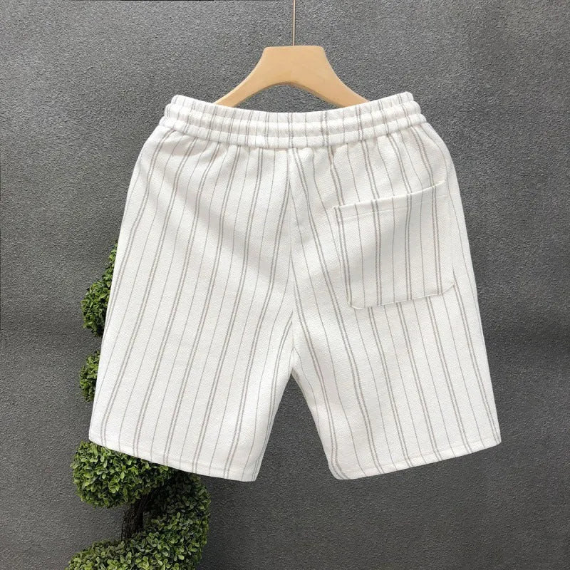 Men's black and white striped fleece-lined casual shorts with an ankle-banded cuff on a hanger.