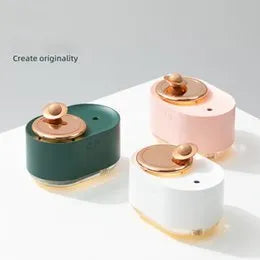 Green rotating planet USB portable humidifier with night light on a wooden desk.