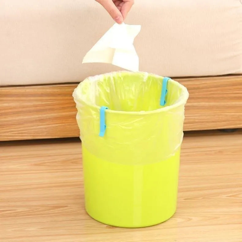 White PP plastic non-slip clip holding a black bin liner to the side of a silver kitchen trash can.