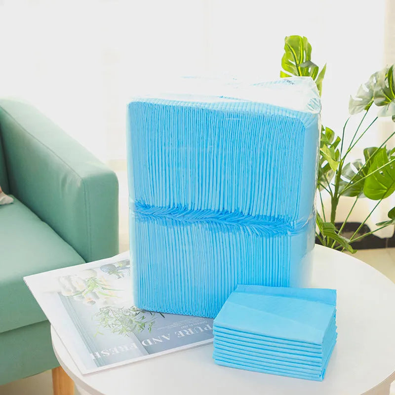 Pack of white pet urinal pads with blue trim, shown alongside a tape measure indicating the 45x60cm M size dimensions.