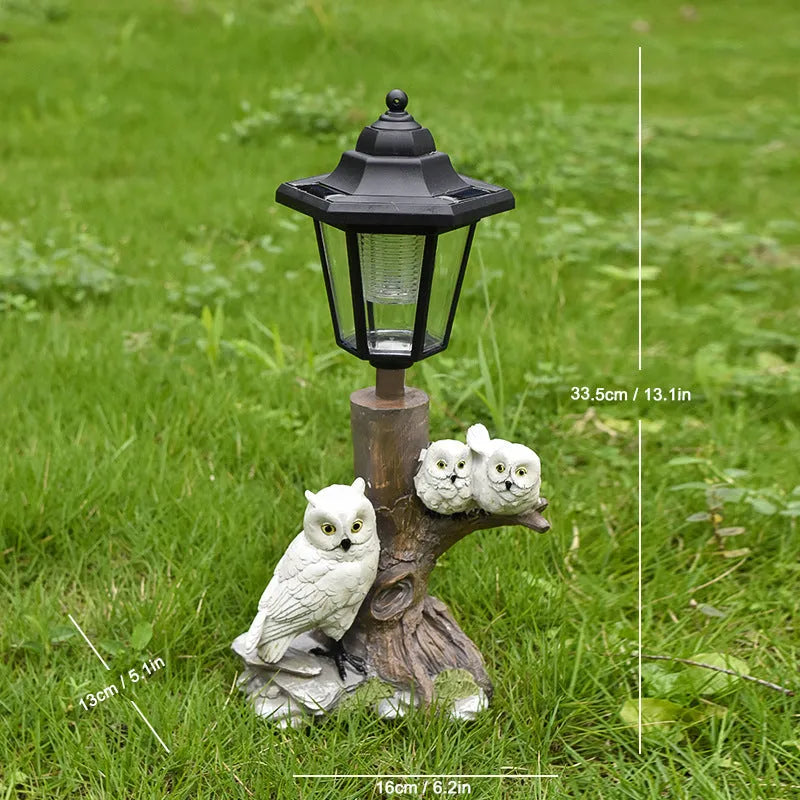 Solar hexagonal garden lamp with decorative resin figurine on plastic base for outdoor pathway lighting